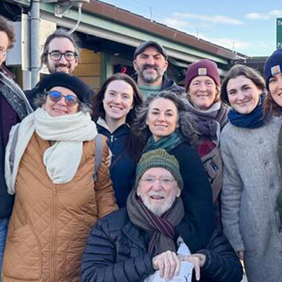 a family stands together outdoors for a group photo