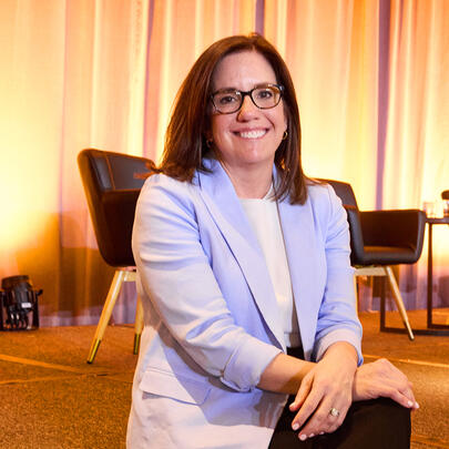 Allie Signorelli sits on a stage at a speaking event