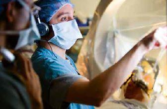 Two doctors performing deep brain stimulation.