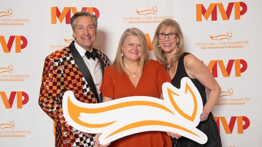 Three people holding up a fox logo cutout at the MVP Gala